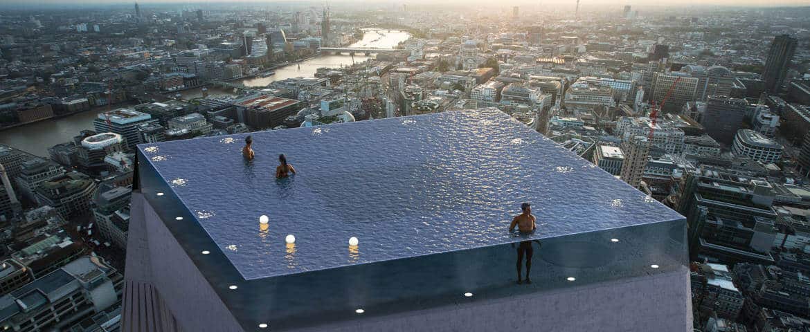 Rooftop infinity pool in London with panoramic views over the London skyline at sunset.