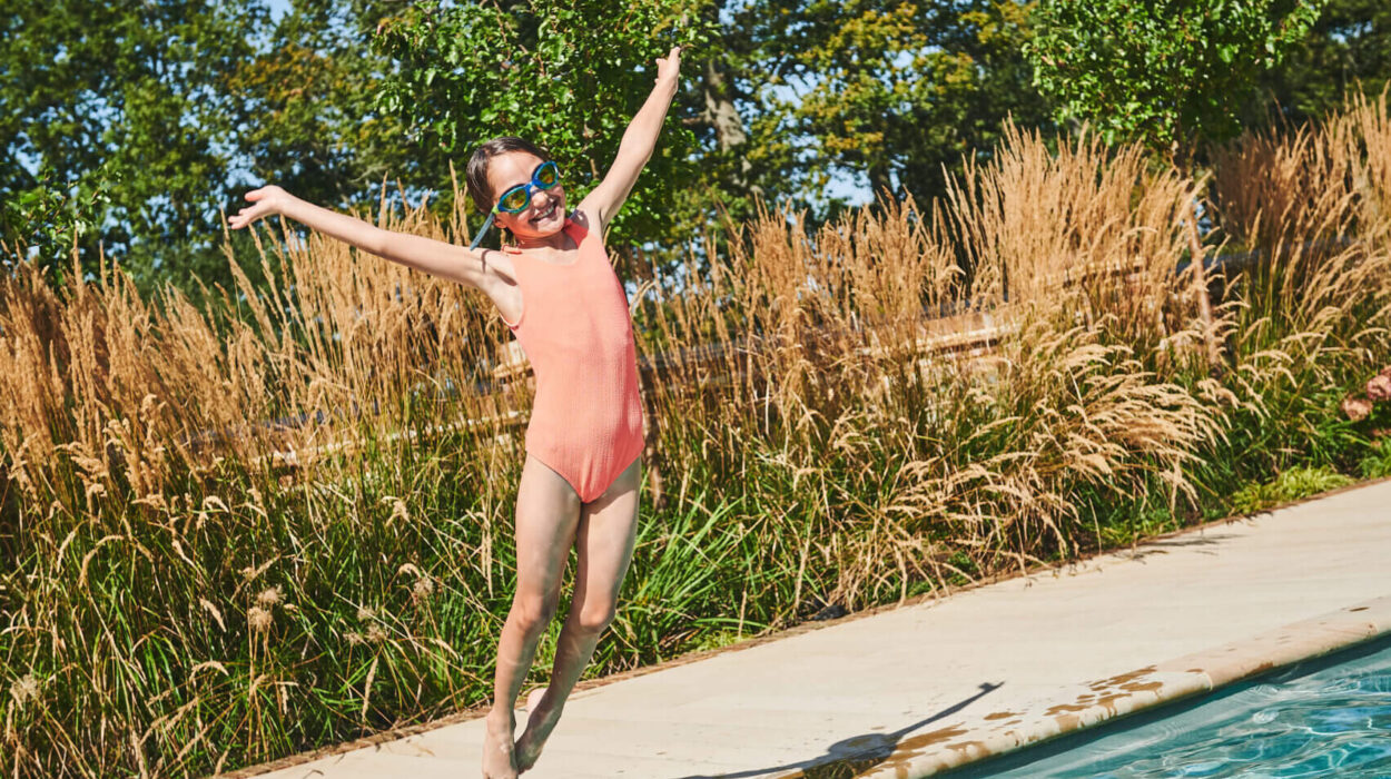 Girl jumping in to a pool