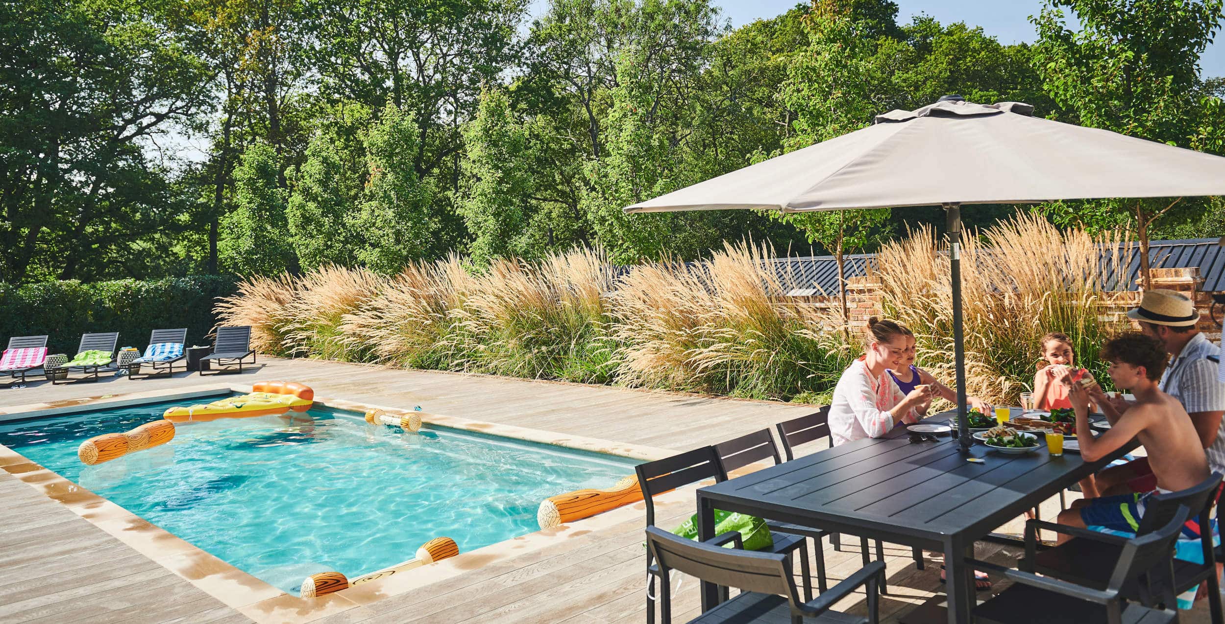 Family meal by the pool