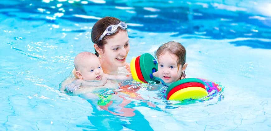 Mother Having Fun in Pool with Children